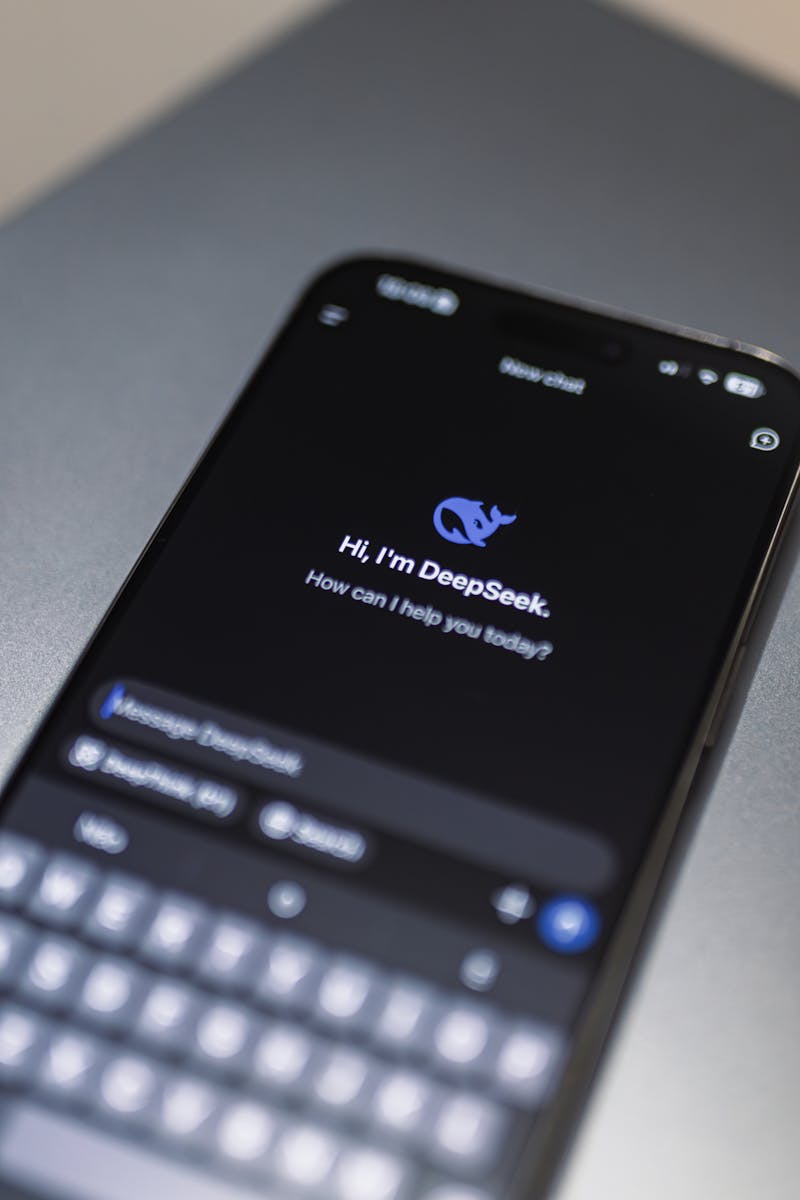 Close-up of smartphone screen showing AI app DeepSeek interface on dark background.