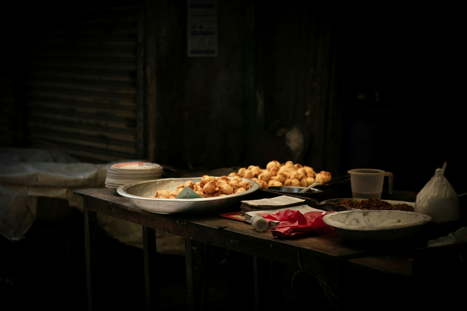 a wooden table topped with plates of food